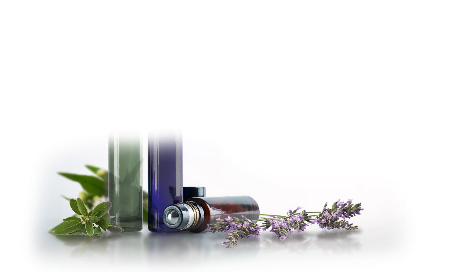 A bottle of essential oil next to a bunch of lavender