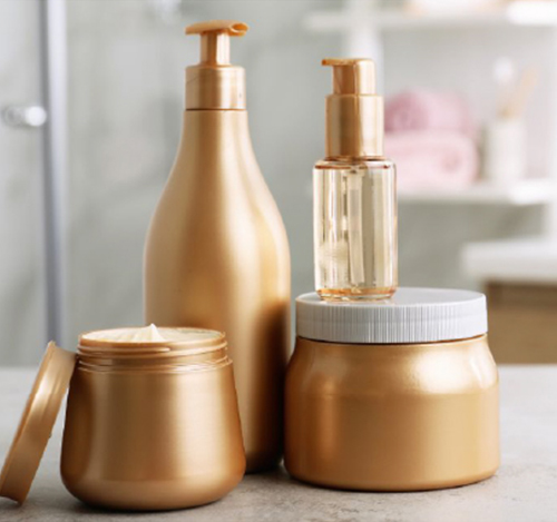 A person holding a spoon over a jar of gel